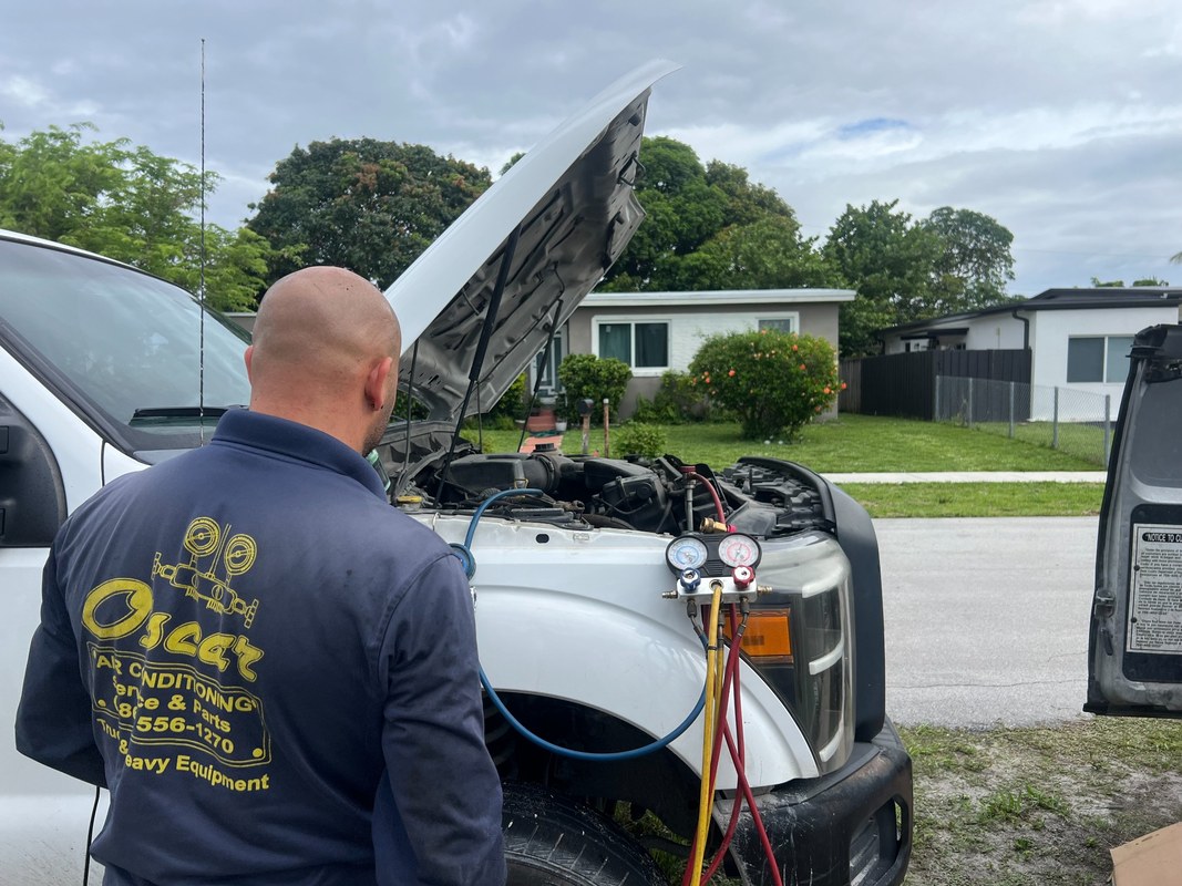 Technician performing mobile truck A/C repair